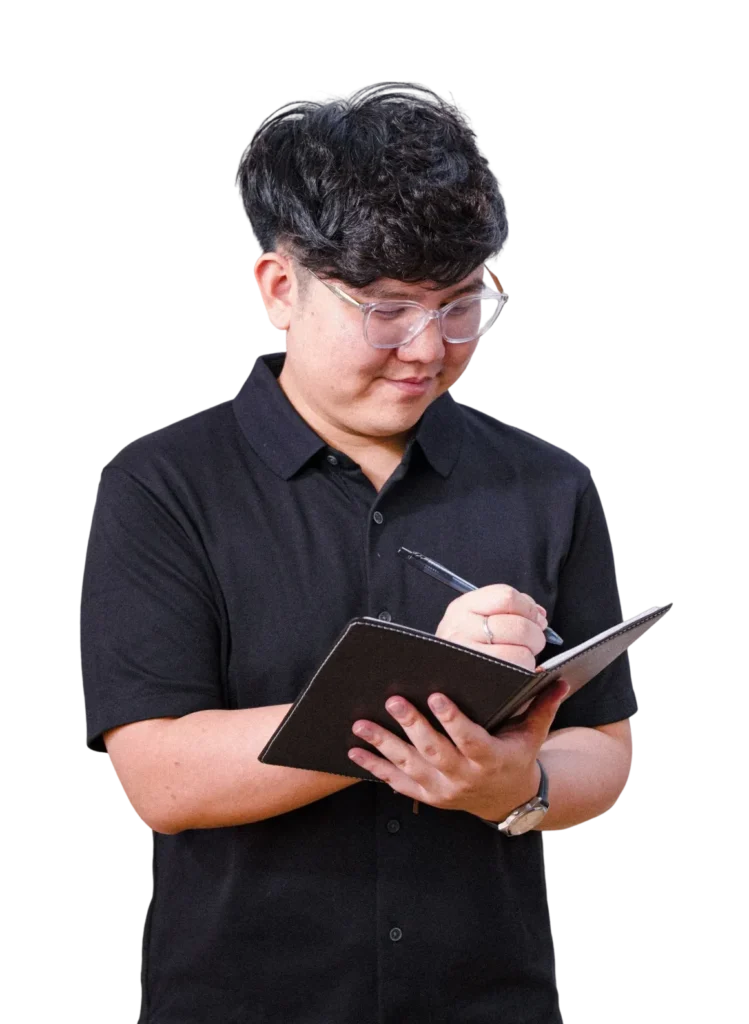 A professional team member standing confidently in a business environment.